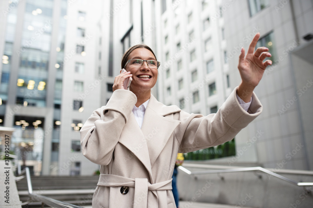 Businesswoman talks with her cell phone during work Businesswoman talks with her cell phone during work