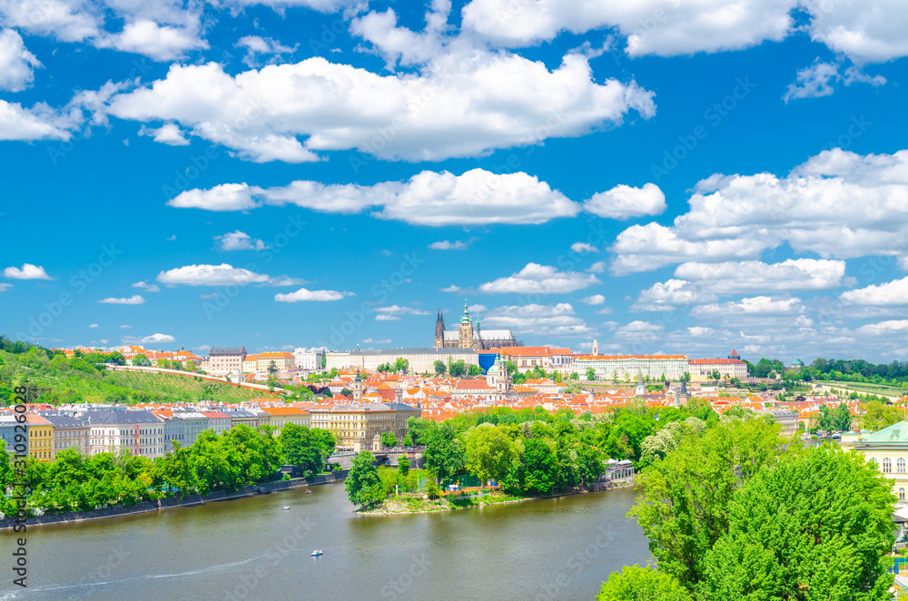 Aerial panoramic view of Prague city, historical center with Prague Castle, St. Vitus Cathedral in Hradcany district, Strelecky island, Vltava river, blue sky white clouds, Bohemia, Czech Republic