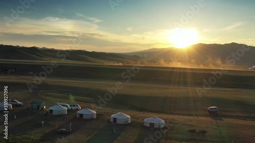 Aerial view of traditional yurts between montains at sunset, Mongolia, 4k photo