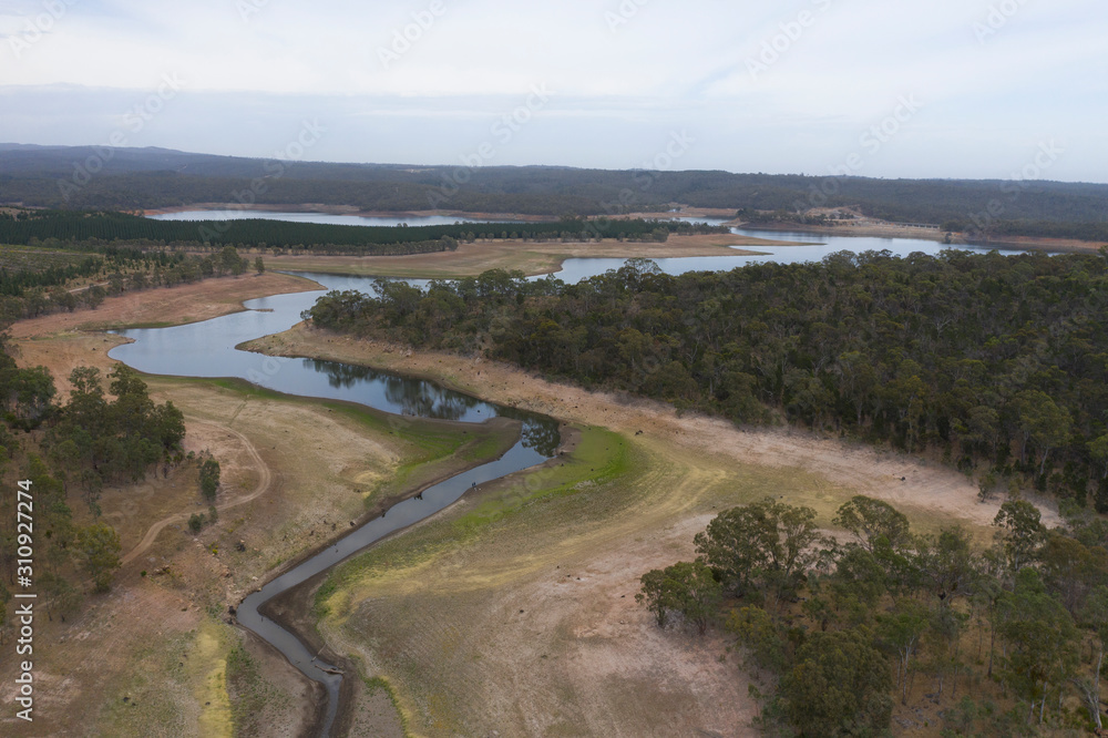 Aerial view of a fresh water reservoir in rural Australia which is reducing due to the extreme drought