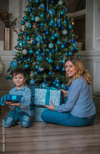 Happy family scene, little kid and mom celebrate Christmas, relationship parents and children © T.Den_Team