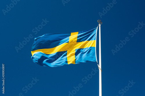 Obraz na płótnie Swedish national flag on blue sky background w salonie