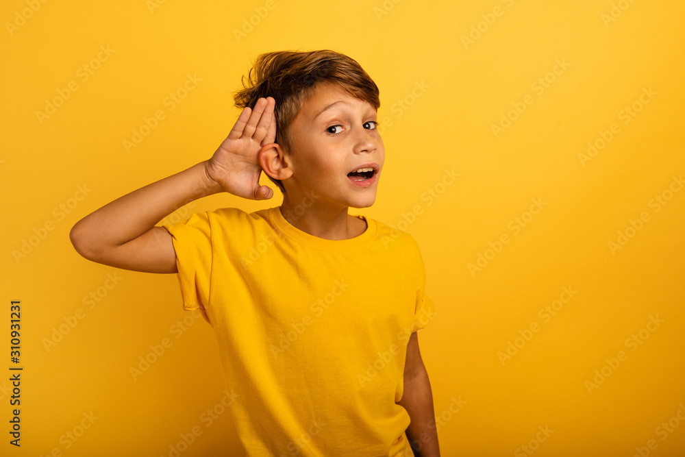 Child hears a secret notice. concept of curiosity and gossip. amazed expression Child hears a secret notice. concept of curiosity and gossip. amazed expression