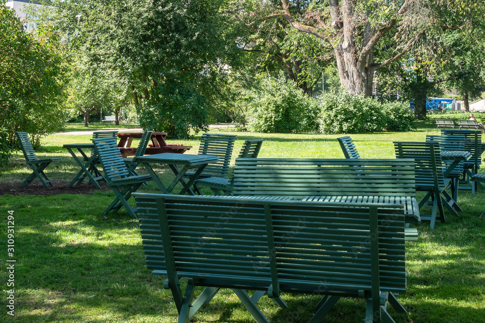 Stadsparken with wooden benches in Uppsala, Sweden