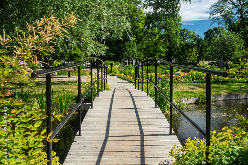 View over a small walking path in the botanical garden with blooming flowers, Uppsala, Sweden