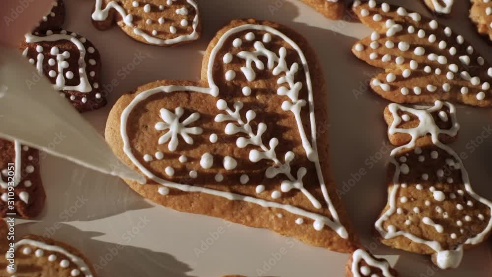 Traditional gingerbread Christmas cookies being decorated. Slow motion. Czech Republic Traditional gingerbread Christmas cookies being decorated. Slow motion. Czech Republic