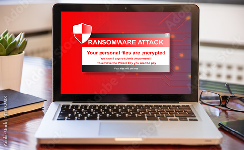 Ransomware attack concept. Ransomware text on a laptop screen photo