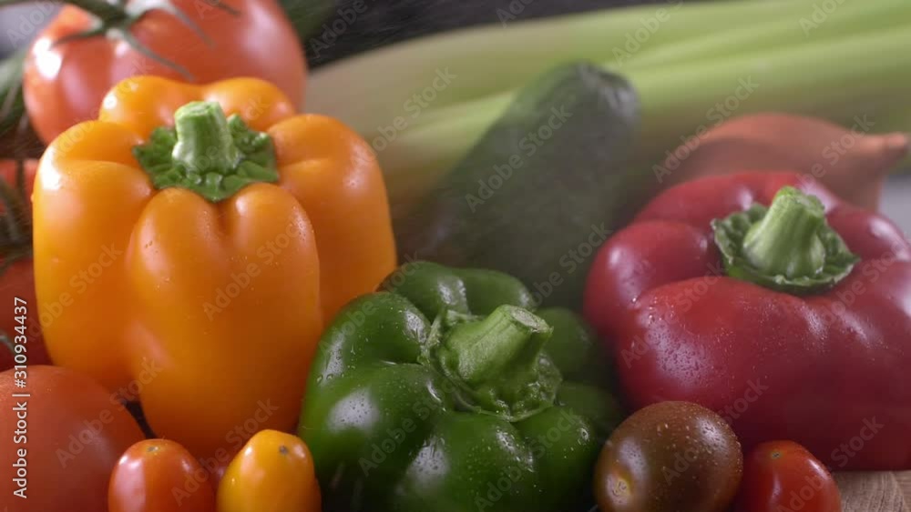 Colored vegetables with water droplets spins in a wooden box,local gardening ,side and macro view.The concept of biological, bio products, bio ecology, grown by own hands, vegetarians, salads healthy Colored vegetables with water droplets spins in a wooden box,local gardening ,side and macro view.The concept of biological, bio products, bio ecology, grown by own hands, vegetarians, salads healthy