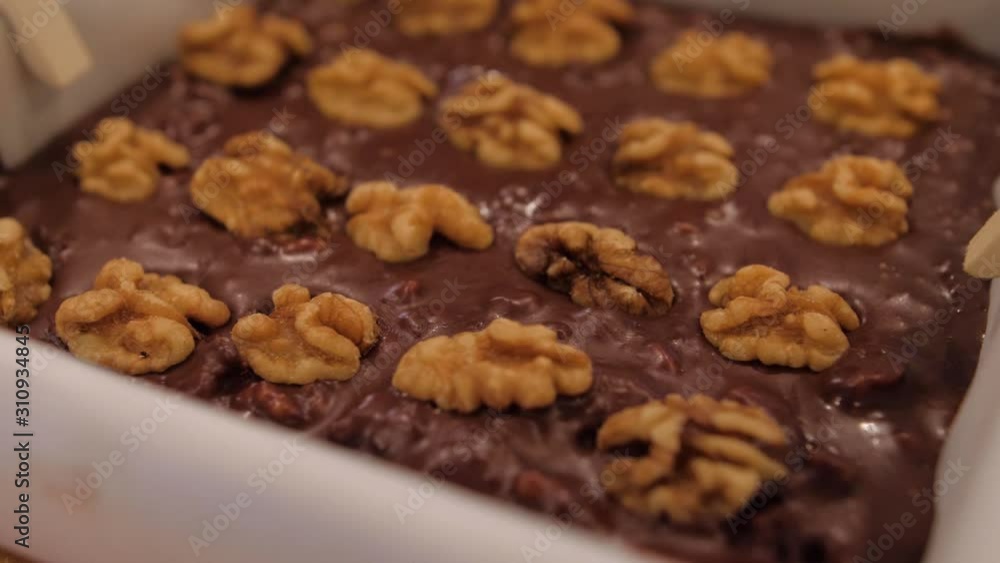 Panning over a tray of chocolate fudge with walnuts. Homemade chocolate desert in pan. Panning over a tray of chocolate fudge with walnuts. Homemade chocolate desert in pan.