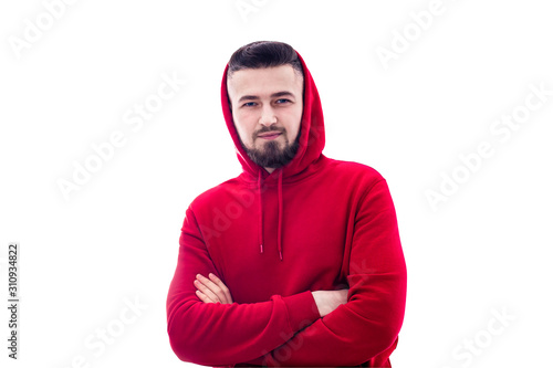 Handsome man in red casual clothes posing with arms crossed on white background