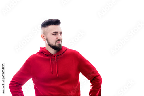 Handsome man in red casual clothes looking to he side on white background