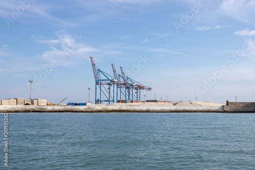 Cargo cranes at the sea docks. Unloading port. © Svetlana