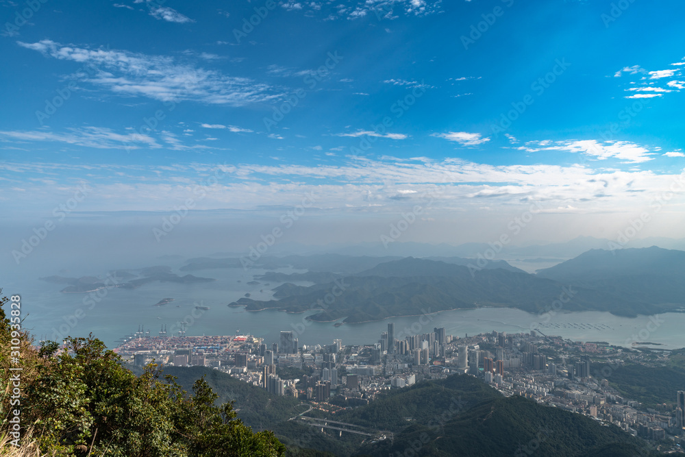 Panorama view of Shenzhen cityscape from top of Wutong Mountain on a sunny day