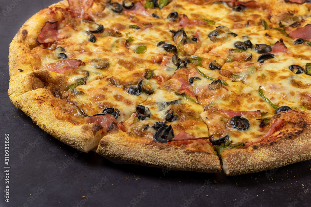 Traditional Italian pizza on a dark background. Rustic style.