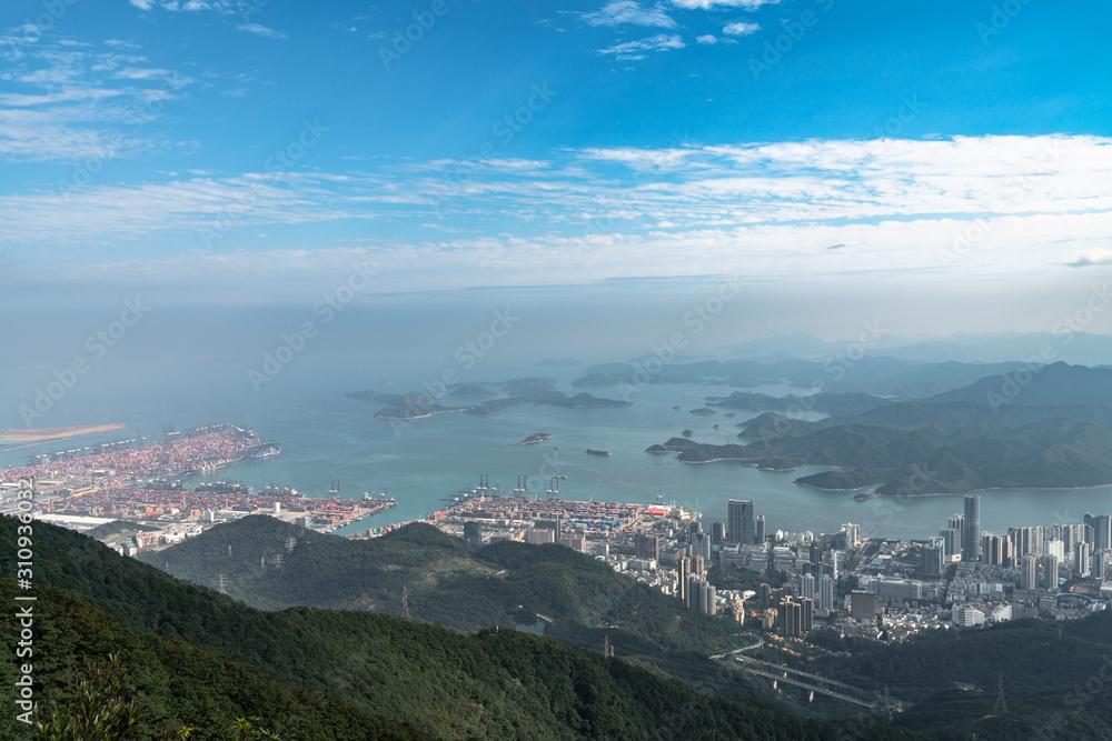 Panorama view of Shenzhen cityscape from top of Wutong Mountain on a sunny day