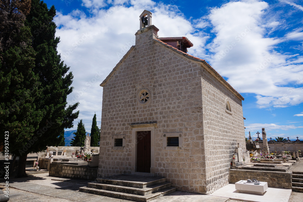 Supetar, Croatia / June 28th 2018: Stone Church in cemetery, Brac Island. Croatia, Europe