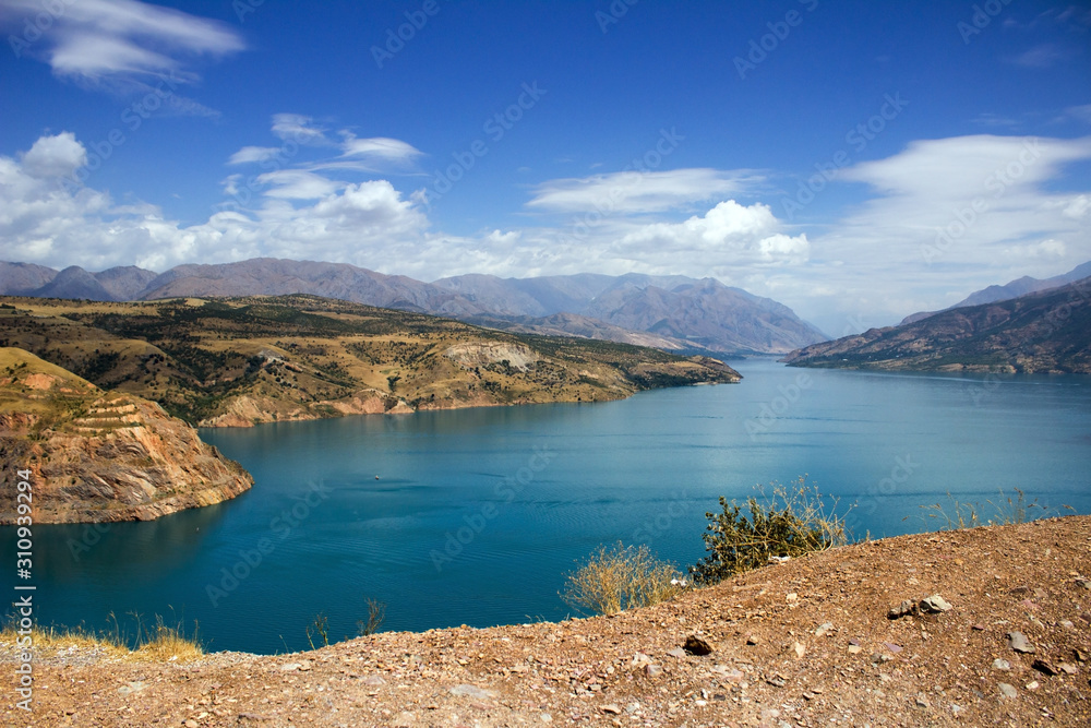 Picturesque landscape and lake, Charvak reservoir, mountains on sunny day background