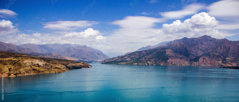 Picturesque landscape and lake, Charvak reservoir, mountains background