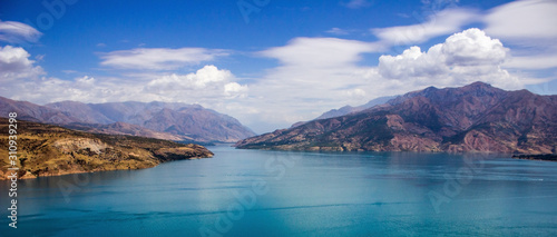 Picturesque landscape and lake, Charvak reservoir, mountains background