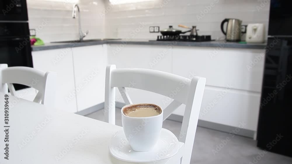 coffee with milk in the morning against the background of the interior of a bright white kitchen coffee with milk in the morning against the background of the interior of a bright white kitchen