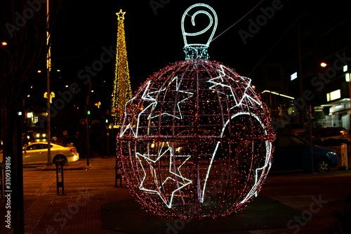 Fototapeta Naklejka Na Ścianę i Meble -  Christmas ball structure with illuminated colorful lights at a street of Athens..