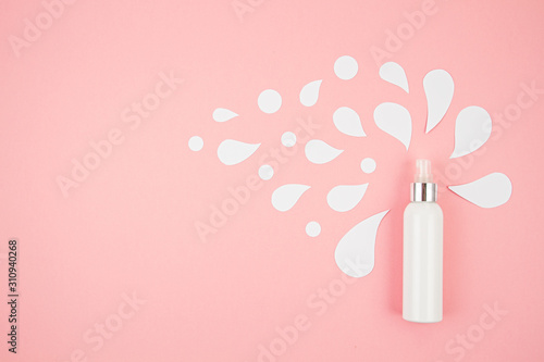 Cosmetic bottle on pastel modern paper background with paper cut splashes. Mock-up for product package branding