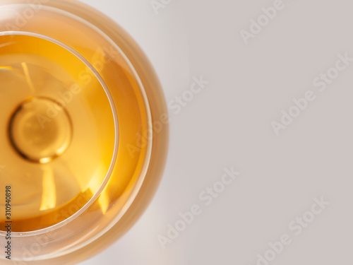 Glass of white wine with shadow with text field.. Top view. Abstract red wine bubbles.