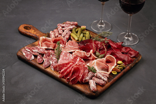 Tableau sur toile Appetizers table with differents antipasti, cheese, charcuterie, snacks and wine