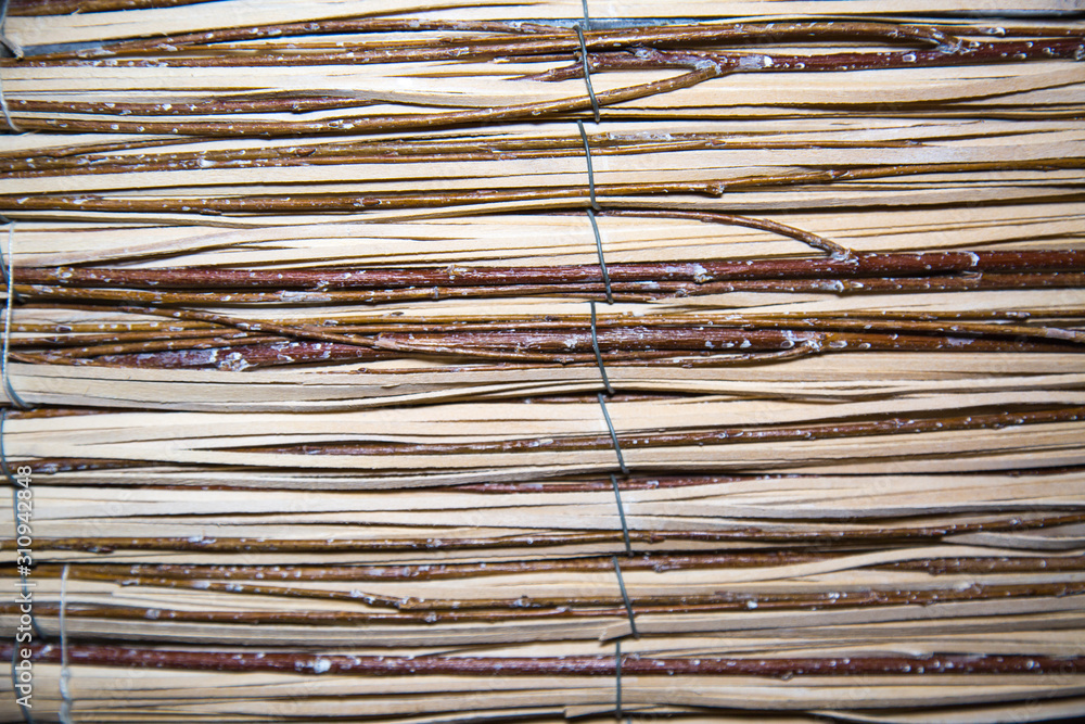 Background of vine twigs held together by metal wire horizontally. Backgrounds, design, structures, textures. Background of vine twigs held together by metal wire horizontally. Backgrounds, design, structures, textures.