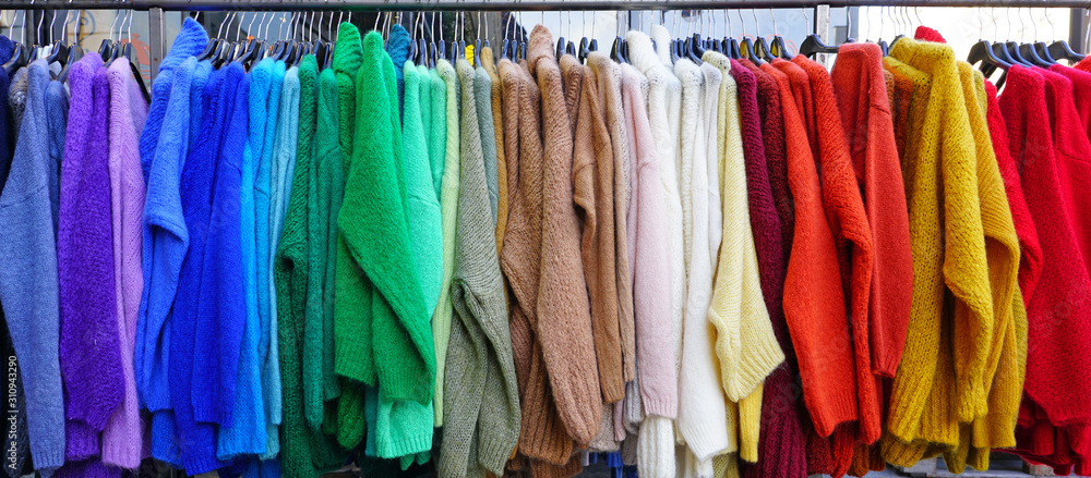 Colorful hanging display of wool sweaters