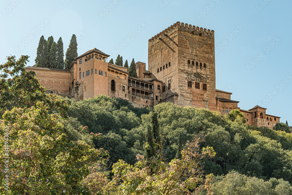 View of the famous palace of Alhambra in Granada, Spain. Low angle view of the majestic palace and fortress