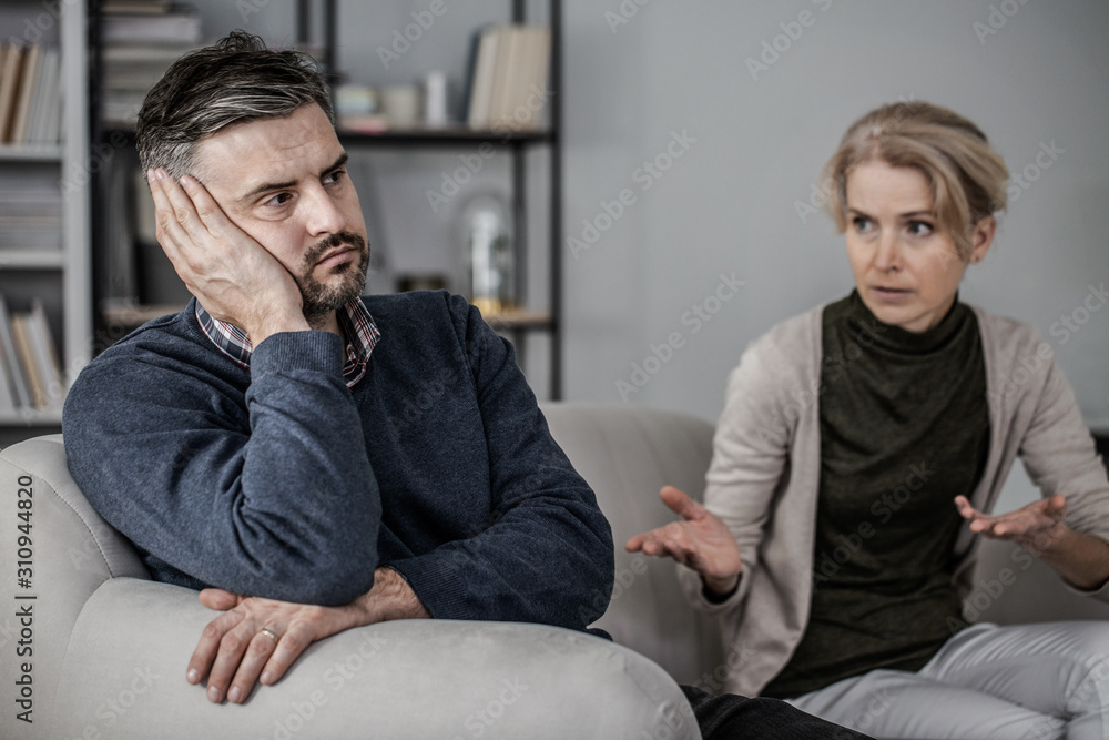 sad and tired husband in the middle of a fight with a cheating wife sad and tired husband in the middle of a fight with a cheating wife