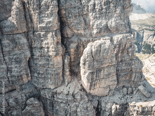 Schilderij op canvas Aerial view of people climbing a via ferrata at the Torre di Toblin (Toblinger K