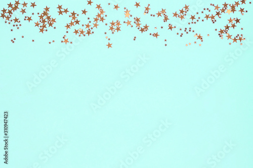 Canvas Print Frame from golden stars glitter confetti on blue background