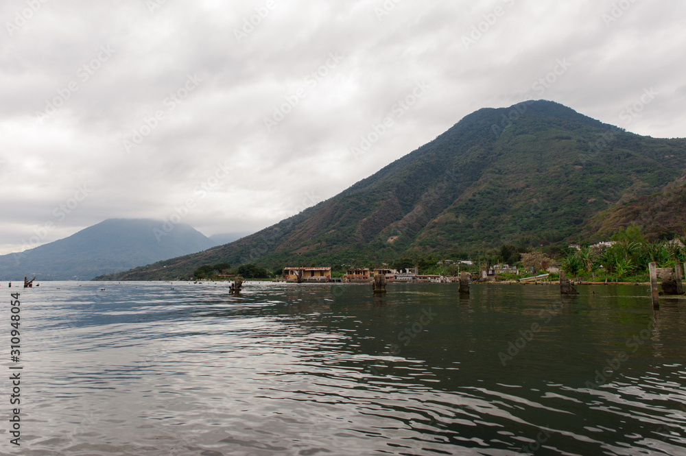 Lakeside onlooking a beautiful volcano on a cloudy day. Lakeside onlooking a beautiful volcano on a cloudy day.