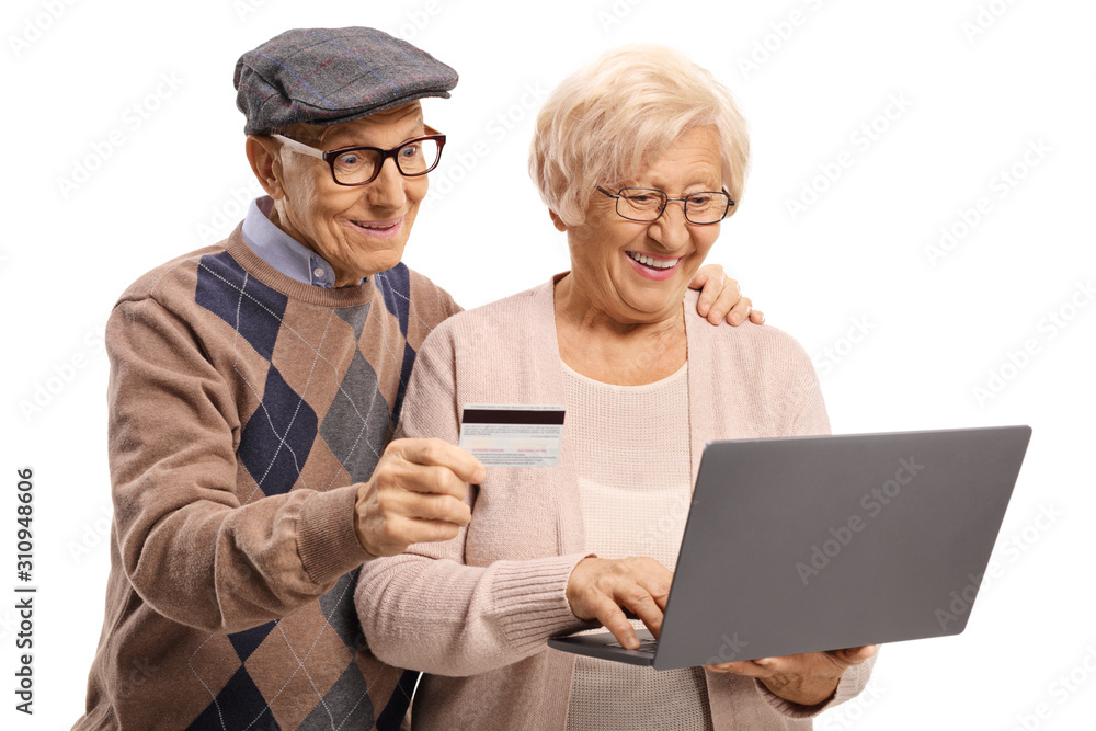 Senior couple using a payment card on the internet with a laptop computer Senior couple using a payment card on the internet with a laptop computer