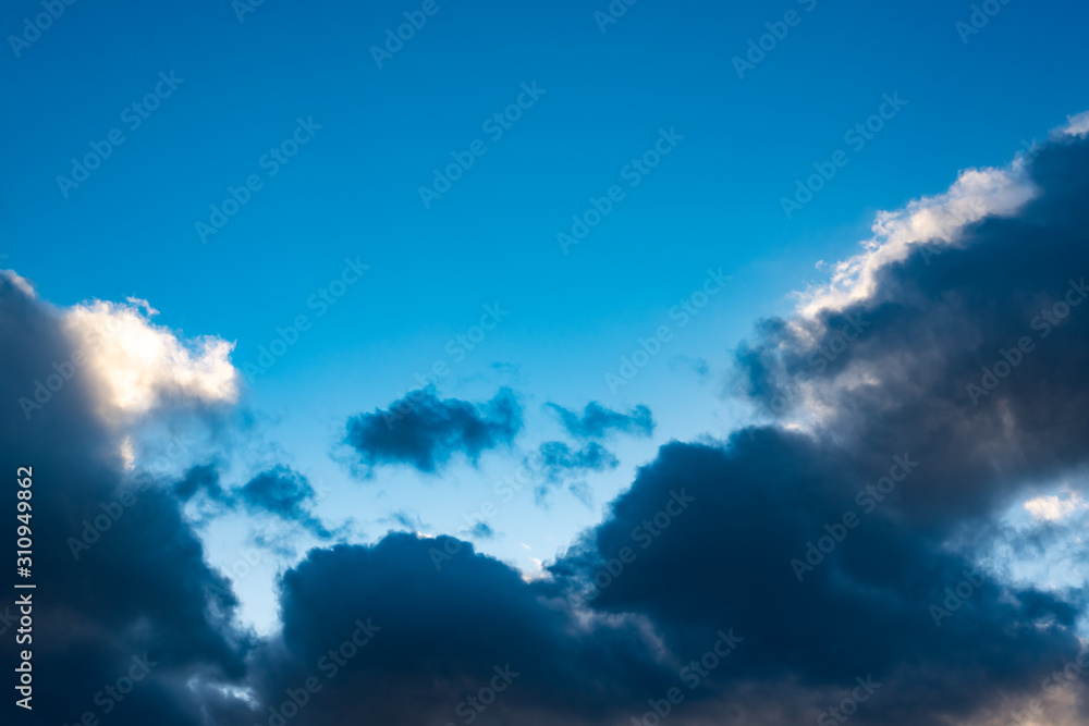 Blue sky with black clouds