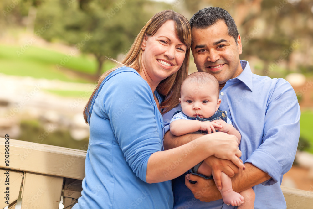 Happy Mixed Race Family Posing for A Portrait in the Park Happy Mixed Race Family Posing for A Portrait in the Park