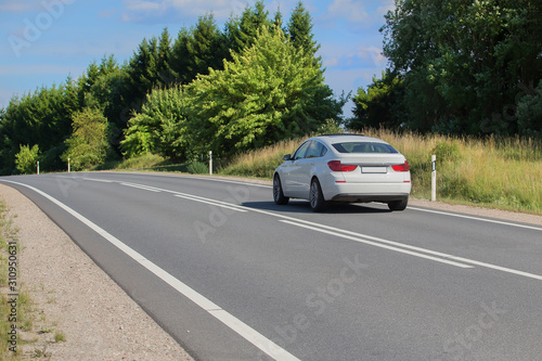 car moves on a country road in summer