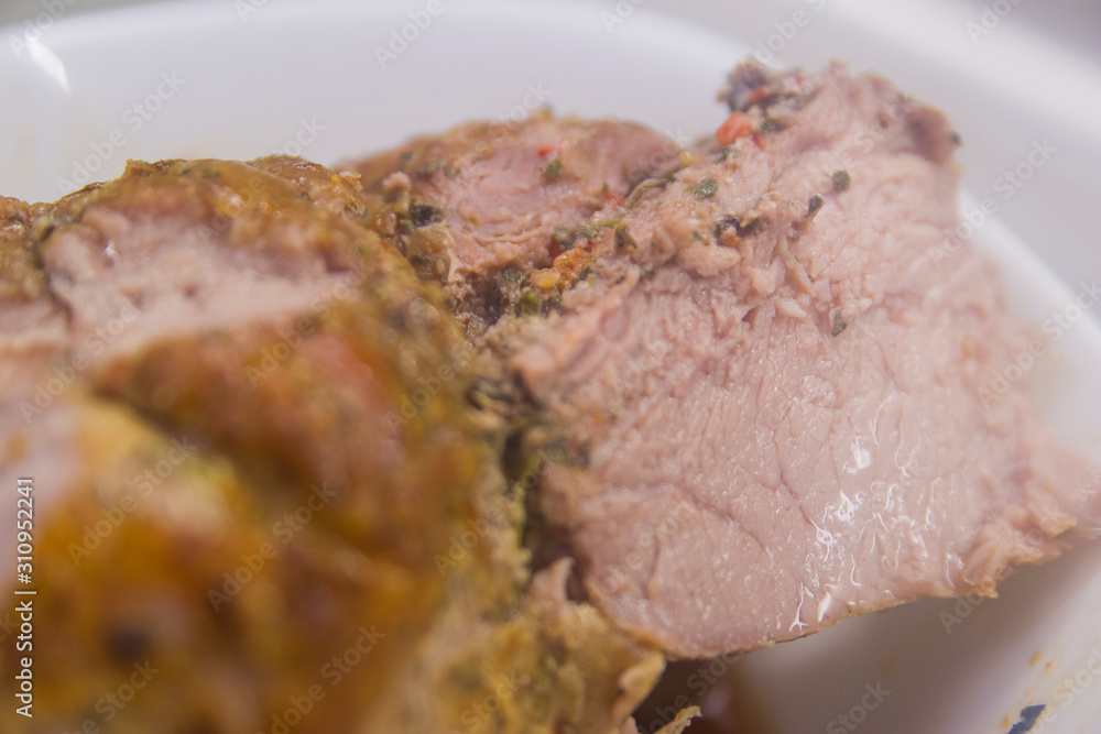A piece of fried meat on a white plate close-up on a gray kitchen table A piece of fried meat on a white plate close-up on a gray kitchen table