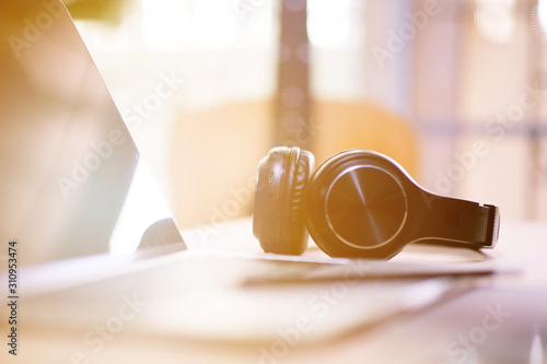 Wallpaper Mural Close-up shots at the black wireless music headphones on the desk. Torontodigital.ca