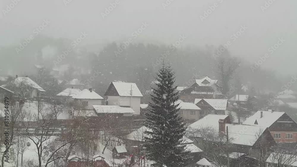 It is snowing in a rural village in Romania It is snowing in a rural village in Romania