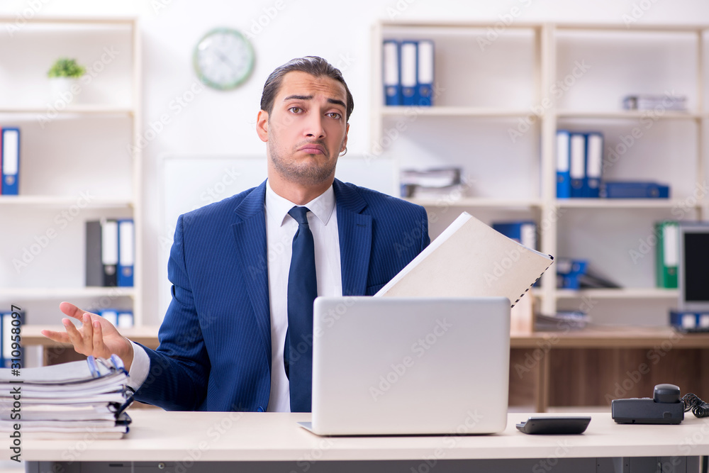 Young male businessman working in the office Young male businessman working in the office
