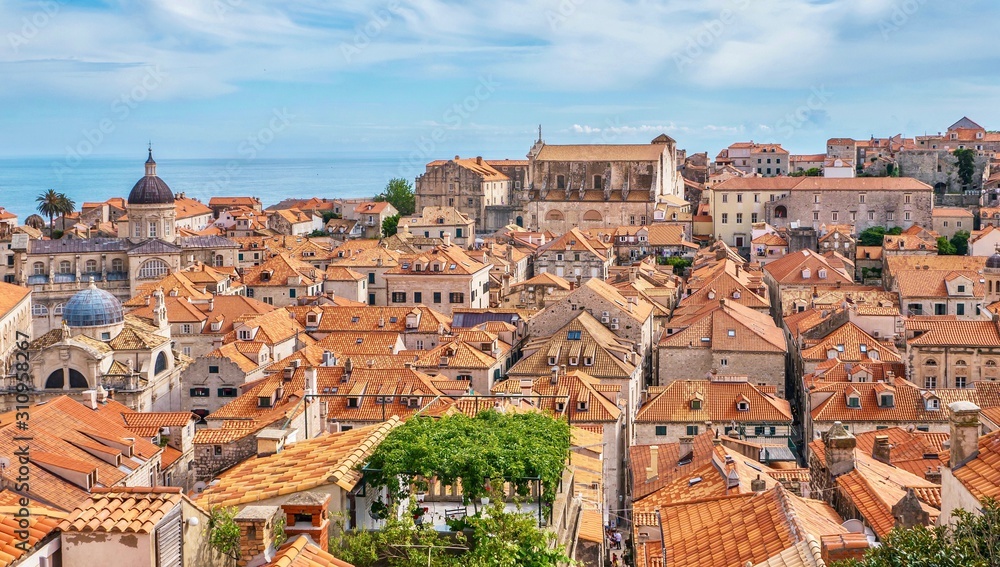 The Old Town of Dubrovnik and its traditional stone buildings and orange tile roof tops.