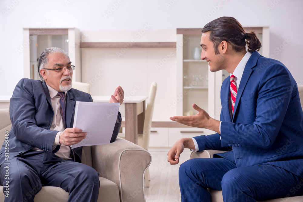 Two businessman discussing business in office Two businessman discussing business in office