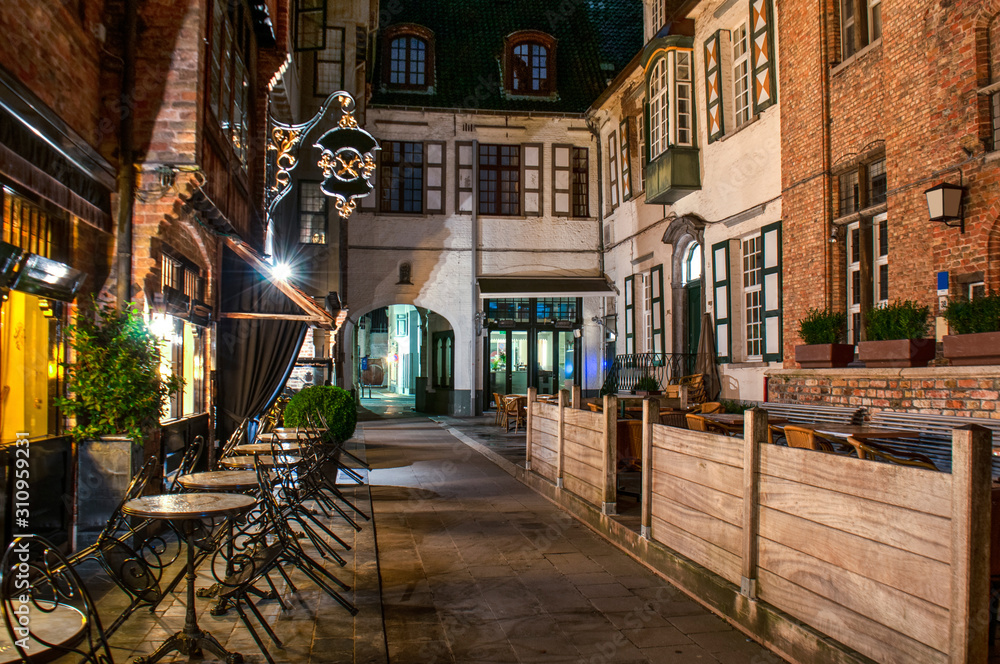 Exterior of a european restaurant in the narrow street at night