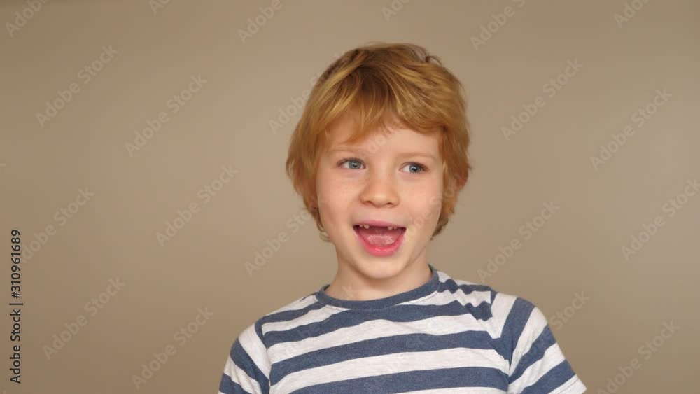 Funny boy with milk tooth gap grimaces in front of the camera Funny boy with milk tooth gap grimaces in front of the camera