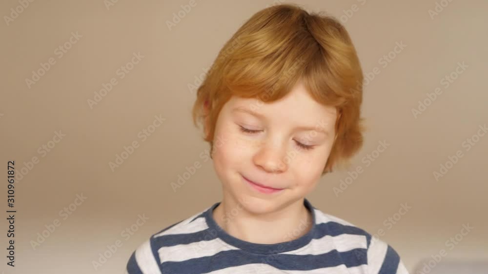 Funny boy with milk tooth gap grimaces in front of the camera Funny boy with milk tooth gap grimaces in front of the camera