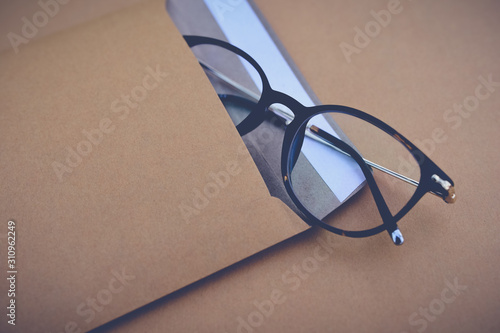 Close up of glasses in envelope. Delivery concept. Vintage tone
