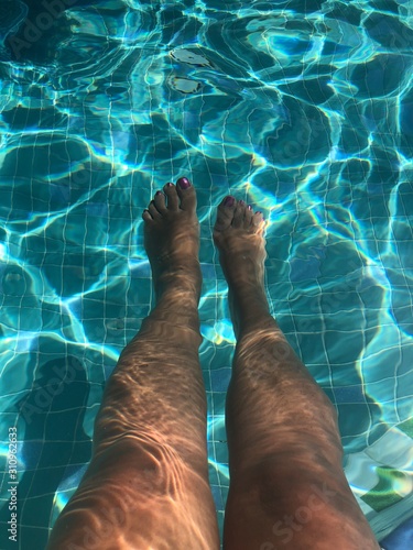 woman legs in the pool